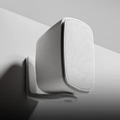 A close-up of the sleek Monitor Audio CL 2S wall-mounted speaker. Its minimalist design and durable construction make it a perfect choice for modern outdoor spaces where both aesthetics and all-weather performance are crucial.