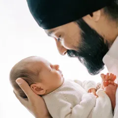 A father's gentle gaze at his newborn child. These are the unscripted, heartfelt moments that become the most treasured family memories.