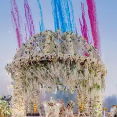 A grand finale to the vows. We coordinated this stunning display of floral structures and colored smoke to create a truly unforgettable exit from the mandap for Aditya and Drishti.