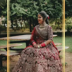 A moment of quiet elegance before the ceremony. This client chose a magnificent maroon bridal lehenga with detailed 'doli' embroidery, adding a beautiful story to her attire.