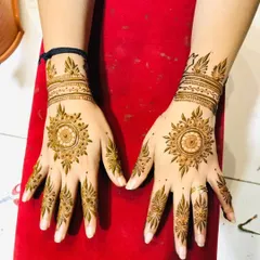 A clean and elegant mandala design for both hands. The pattern is centered on the back of the palm with simple, matching designs on the fingers and wrists.