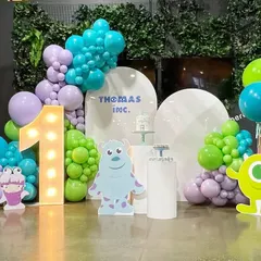 We handle corporate family days and anniversaries with creative, fun themes. This 'Monsters, Inc.' setup for Thomas Inc. included character cutouts, themed balloon colors, and a large light-up number to celebrate their milestone.