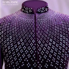 A close-up of the collar and shoulder of the purple velvet Jodhpuri, where the intricate silver beadwork is most concentrated.