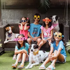 Five kids, three dogs, and one very happy photographer! This fun, chaotic, and colorful group shot with silly glasses perfectly captures the energy of a big, happy pack.