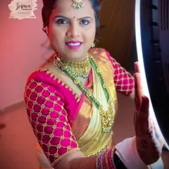 A close-up of this bride's radiant smile, ready for her wedding rituals. The makeup is designed to be bright and photogenic, enhancing her features while still looking natural.