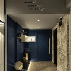 The entrance corridor at Paarkhi, where a deep blue grooved wall creates a dramatic and textural backdrop. A custom-lit marble shelf and floor-level lighting guide the eye through the space, building anticipation.