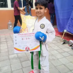 A young champion proudly holds his certificate and trophy. This victory is a result of countless hours of practice and unwavering focus.