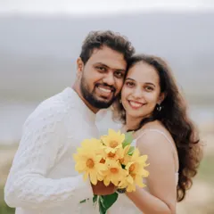 A bright and happy portrait of the couple with a bouquet of sunflowers. Their genuine smiles make this a heartwarming and cheerful image.