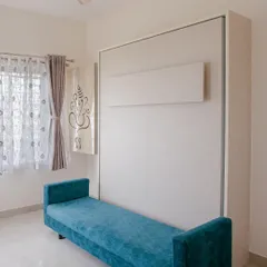 Here is the same Murphy bed, folded away to reveal a comfortable and chic blue sofa. This is how we create multifunctional spaces that work for you day and night.