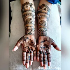 This bridal mehendi tells a complete story, from the couple's portraits on the palms to the regal elephants and palace architecture on the forearms. Every element is customized to create a design that is deeply personal.