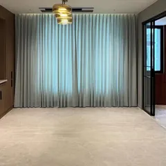 A wide shot of a custom storage unit in a penthouse project. The design includes both closed cabinets for storage and open sections with a marble backsplash, blending functionality with high-end finishes.