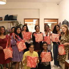 A happy group from our 'Holidye Magic' Christmas workshop, proudly showing off the festive tote bags they dyed. Group workshops are a wonderful way to celebrate special occasions together.