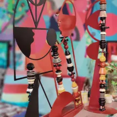 A close-up of our 'HYBRIDS' sculptures, which combine abstract metal silhouettes with colorful, hand-lacquered Channapatna wooden toy elements. This creates a fusion of contemporary sculpture and traditional Indian handicraft.