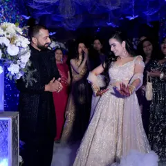 A dreamy dance sequence at Kiran and Shourya's Sangeet. The low smoke and dramatic blue lighting create a cinematic atmosphere, making it feel like a scene from a movie.