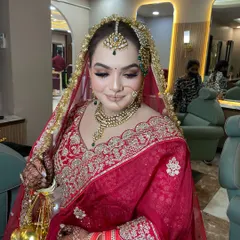 The complete bridal look for Dipika. The intricate hair accessory, the stunning jewelry, and the flawless makeup all come together to create a breathtaking vision.