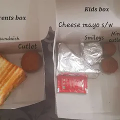 I love creating separate menus for kids and parents. Here, the kids' box has a cheese mayo sandwich and mini cutlets, while the parents' box contains a grilled sandwich and a larger cutlet.