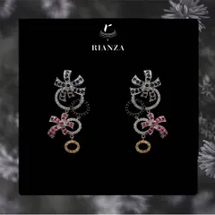 These whimsical statement earrings feature a playful design of floral bows made from blue sapphires, rubies, and diamonds. They are a unique piece for someone who loves creative jewellery.
