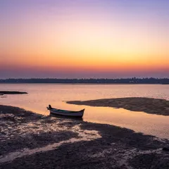 A lone boat rests on the shore during a beautiful sunset in Brahmavara. Life by the coast offers many insights, and the free therapy of "Vitamin Sea" is available to anyone with the time.