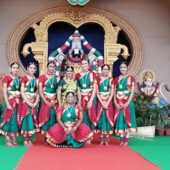 The full team of my girls who performed at Tirumala, posing with me before the magnificent temple backdrop. It was a day of devotion, dance, and unforgettable memories.
