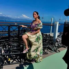 This behind-the-scenes shot captures the drama and beauty of the Yara Shoemaker gown against the open sea.