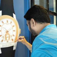 Here I am adding the final details to a large, hand-painted Aigner watch mural. This kind of detailed product artwork is a great way for a brand to showcase its flagship items in its office or showroom.