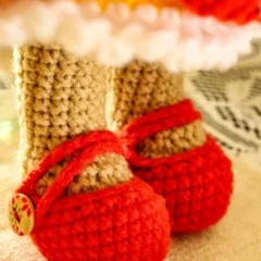 A close up of Lily's tiny red shoes, complete with little button clasps. Her shoes, like her dress, are completely removable, making dress-up play even more fun.