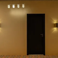 The entrance to our marriage hall masterpiece. The design uses a combination of modern overhead lighting and classic wall sconces to create a warm and welcoming ambiance for arriving guests.