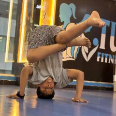 We help kids discover their strength and coordination through dynamic movements. This student is mastering a challenging breakdance freeze, building core strength and confidence on our matted studio floor.