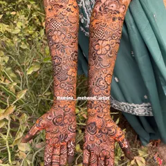 A complete bridal mehendi design for both arms, showcasing the rich texture and depth created by mixing fine lines with bold, filled elements.