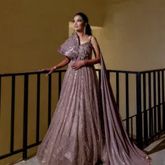 The bride, Karishma, looks absolutely radiant in her reception gown. I captured this moment on the balcony, using the soft lighting to highlight the elegance of her dress and her joyful anticipation.