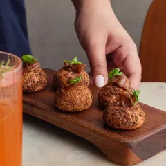 This dish has been on our menu since day one. The Chicken Liver Parfait Choux Buns are topped with a moreish red wine and balsamic onion jam. It's my take on a classic French flavor combination.