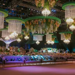 This is how I transform a grand hall into an enchanted forest. For this soirée, I suspended dozens of custom chandeliers dripping with crystals and florals from emerald green ceiling installations, creating an immersive canopy of light and opulence.