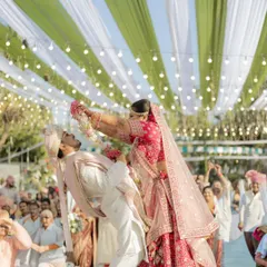 The varmala isn't just a ritual; it's a playful battle of love. I'm always ready to capture these fun, unscripted moments that show your unique chemistry and the pure joy of your shaadi.