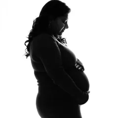 A classic black and white silhouette. This style of portrait is timeless and focuses entirely on the beautiful shape of the baby bump.