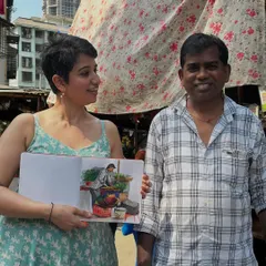 One of my favorite things is connecting with people through my art. Here I am with a local vegetable vendor after sketching him at his stall. Seeing the joy on someone's face when they see themselves captured in a sketch is the best feeling.