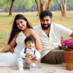 A perfect family picnic scene. This happy family of three enjoys a beautiful day outdoors, creating a relaxed and natural family portrait.