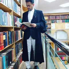 In the law library, surrounded by legal texts. Continuous learning is a non-negotiable part of my practice, ensuring I bring the most current knowledge to your case.