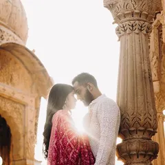 A beautiful, sun-kissed moment from a Jaisalmer pre-wedding shoot. The makeup is soft and romantic, with warm tones to complement the golden light and historic architecture. The hair is styled in loose waves for an effortless feel.