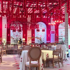 Inspired by the vibrant aesthetics of Jaipur, this 'Laal Ishq' theme uses a bold palette of red and white. The entire space, from the custom chandeliers to the block-print motifs and table settings, was designed to create a symphony of color and romance.