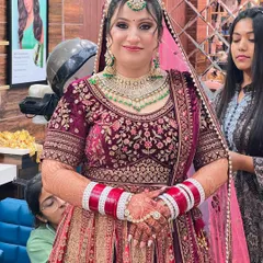 A happy bride in a stunning maroon and gold lehenga. We provided a complete bridal package, including hair, makeup, and dressing assistance.