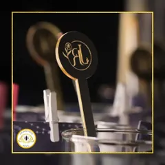 A close-up of our custom-designed stirrers, featuring the couple's initials. It's a simple, elegant way to personalize the bar experience for your wedding.