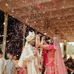 Another angle of the joyful varmala exchange, capturing the couple's interaction and the celebratory atmosphere.