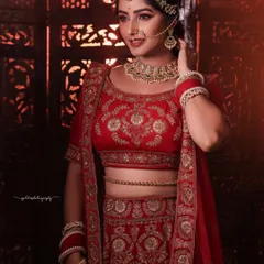 A series of portraits showcasing a model in a heavily embroidered red bridal lehenga. I focused on capturing the intricate details of the outfit and the flawless bridal makeup, presenting a look of regal elegance.