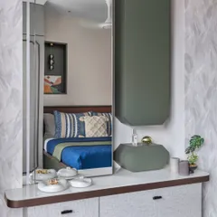 This bedroom was designed for grandparents, with simple wooden details to bring in an old-world charm. The custom dressing unit has a large mirror and integrated storage for a functional, elegant touch.