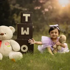 The warm glow of the setting sun adds a magical touch to this outdoor second birthday photo. I love using natural light to create beautiful, atmospheric images.