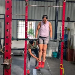 My coaching philosophy is simple: mechanics, consistency, then intensity. Here, I'm providing hands on support to help a client master the mechanics of a bar dip, ensuring she builds strength on a solid foundation of proper form.