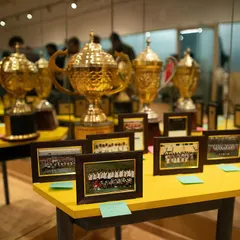 Another view of our legacy. Framed photos of past teams sit alongside the cups they won, connecting our current players with the history of the club they represent.