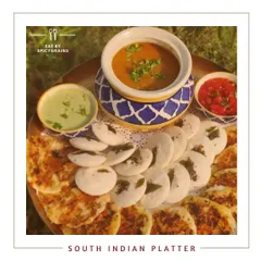 A taste of the south with our South Indian Platter. This spread features fluffy mini idlis and crispy uttapams, served with traditional sambar, coconut chutney, and tomato chutney for a complete and authentic breakfast or brunch.