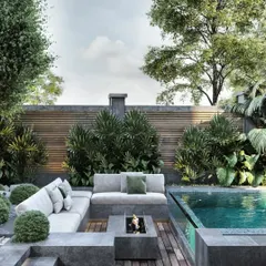 A luxurious poolside retreat designed for ultimate relaxation. This landscape plan features a modern fire pit, comfortable all-weather sofas, and lush, layered planting that provides privacy and a tropical feel. The combination of stone, wood, water, and fire creates a balanced and sophisticated outdoor lounge.