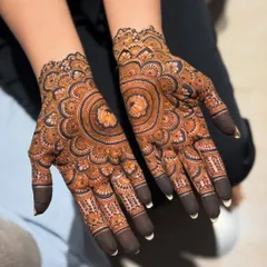 The gorgeous dark stain of a Teej mehendi, featuring a full-palm mandala with intricate layers. This is what I call 'stain goals'.